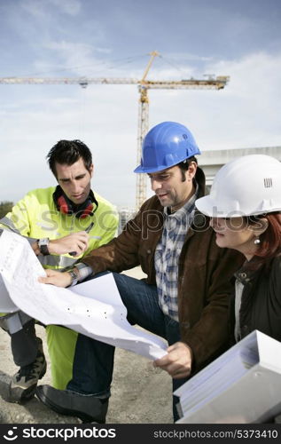 Construction team looking at plans