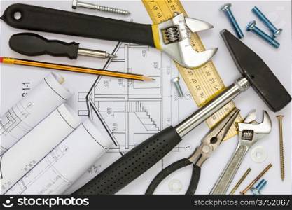 Construction tools and blueprints for a new house project