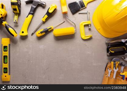 Construction tools and grey concrete background. Construction concept