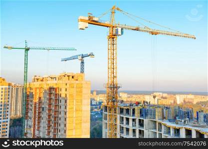 Construction with cranes on industrial building site