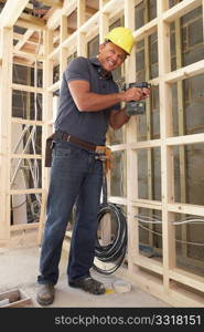 Construction Worker Building Timber Frame In New Home