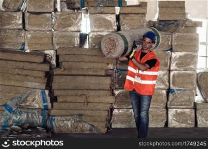 Construction worker carring steel wood