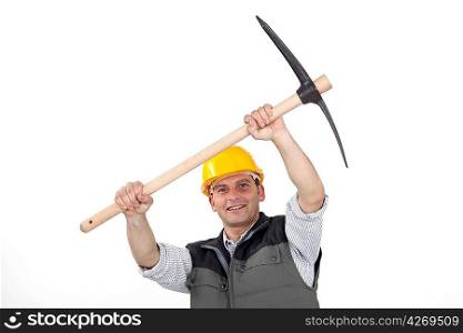 Construction worker carrying a pickaxe