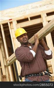 Construction Worker Carrying Lumber