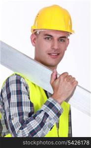 Construction worker carrying metal