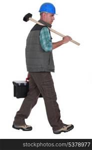 Construction worker carrying tools