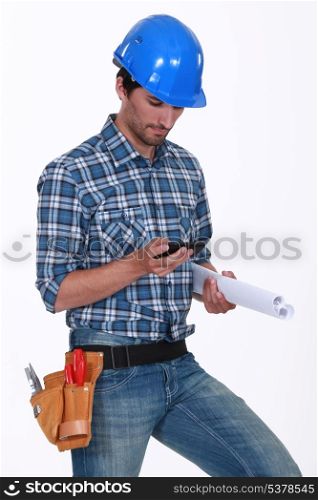 Construction worker checking his phone