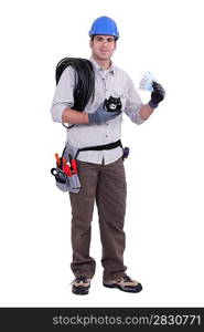 Construction worker holding a piggy bank and money