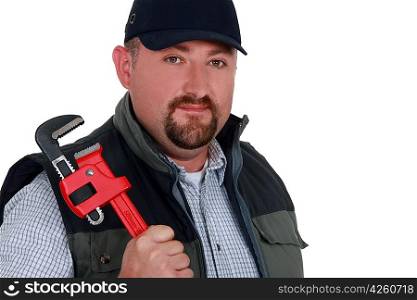 Construction worker holding a pipe wrench