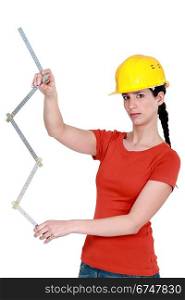 Construction worker holding a ruler