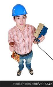 Construction worker holding a sander.