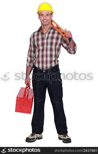Construction worker holding a toolbox and spirit level