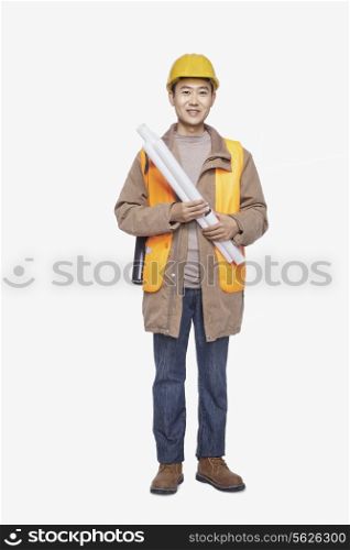 Construction worker holding blueprint against white background, portrait