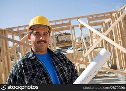 Construction worker holding building plans