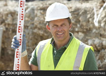 Construction Worker Holding Measure