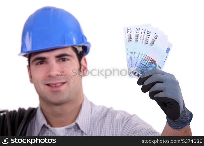 Construction worker holding money