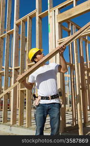 Construction worker holding planks