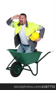 Construction worker in a wheelbarrow