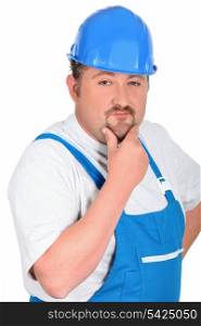 Construction worker in blue overalls