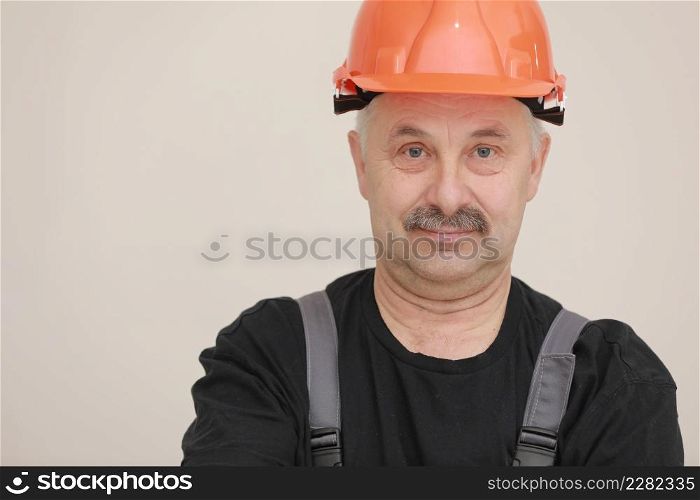 Construction worker in overalls and hard hat. Repairman with a mustache. Business, technology. Building concept. Studio shot on white background.. Construction worker in overalls and hard hat. Repairman with a mustache. Business, technology. Building concept. Studio shot on white background
