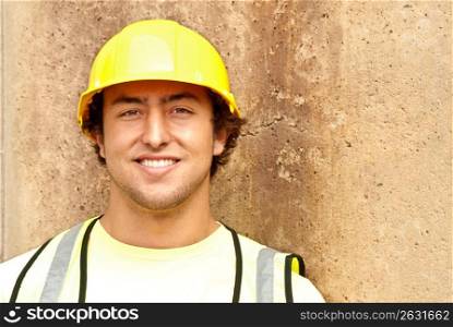 Construction worker in reflective vest and hard-hat smiling
