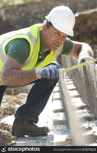 Construction Worker Laying Foundations