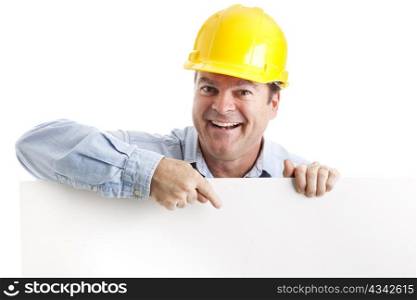 Construction worker leaning over and pointing to blank white space. Isolated.