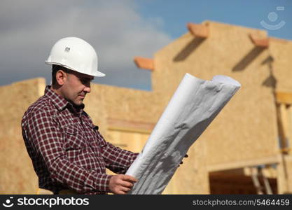 Construction worker looking at a drawing