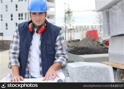construction worker looking at his plans