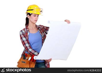 Construction worker looking at plans