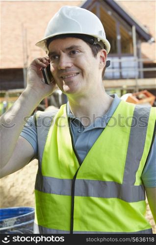 Construction Worker On Building Site Using Mobile Phone