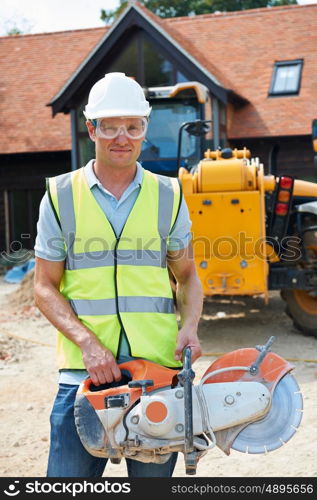 Construction Worker On Site Holding Circular Saw