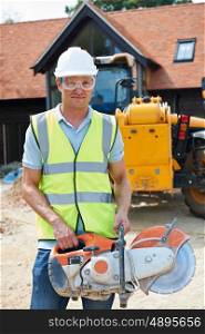 Construction Worker On Site Holding Circular Saw
