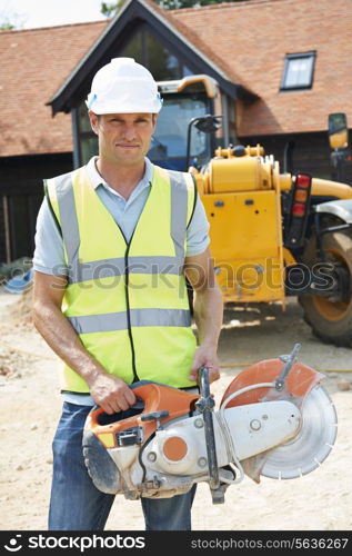 Construction Worker On Site Holding Circular Saw