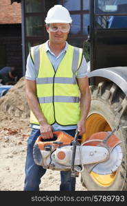 Construction Worker On Site Holding Circular Saw