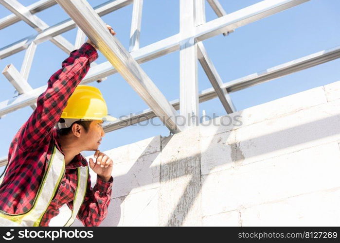 Construction worker or contractor checking house frame, worker roofer builder working on steel roof structure on building  construction site