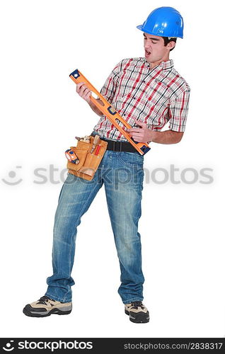 Construction worker playing air guitar