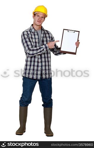 Construction worker pointing to a blank clipboard
