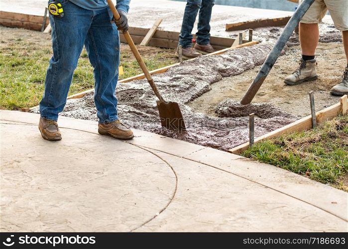 Construction Worker Pouring Wet Deck Cement Into Wooden Frame