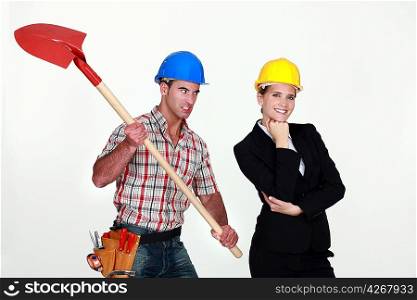 Construction worker preparing to hit an engineer over the head