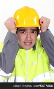 Construction worker protecting his head