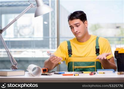 Construction worker sitting at the desk