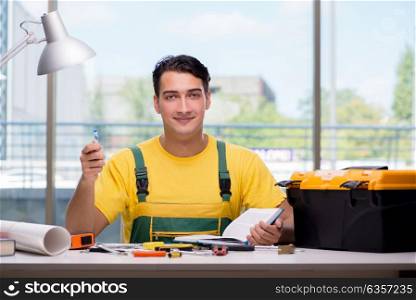 Construction worker sitting at the desk