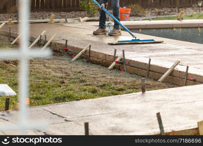 Construction Worker Smoothing Wet Cement With Trowel Tool