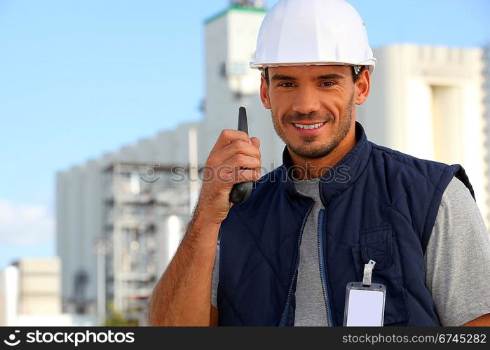 Construction worker speaking into his walkie-talkie