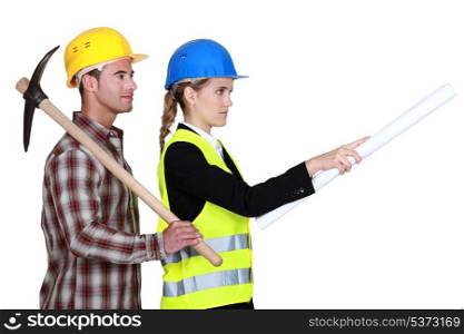 Construction worker standing with engineer