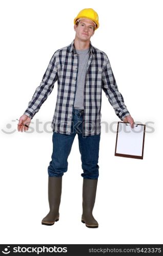 Construction worker standing with notepad in hand