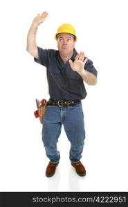Construction worker trapped in imaginary box. Full body isolated on white.