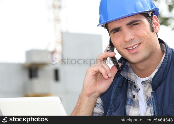 Construction worker using a mobile phone