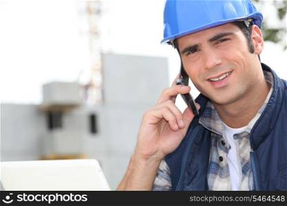 Construction worker using a mobile phone